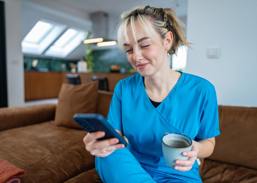 Healthcare woman smiling while using her phone