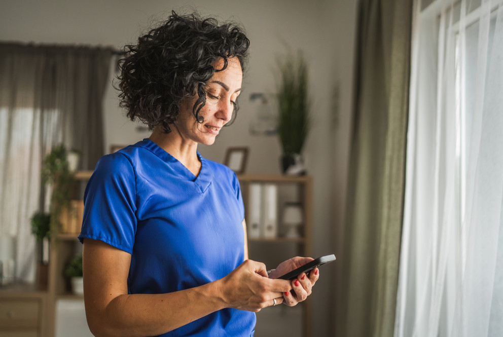 Caregiver using her mobile device